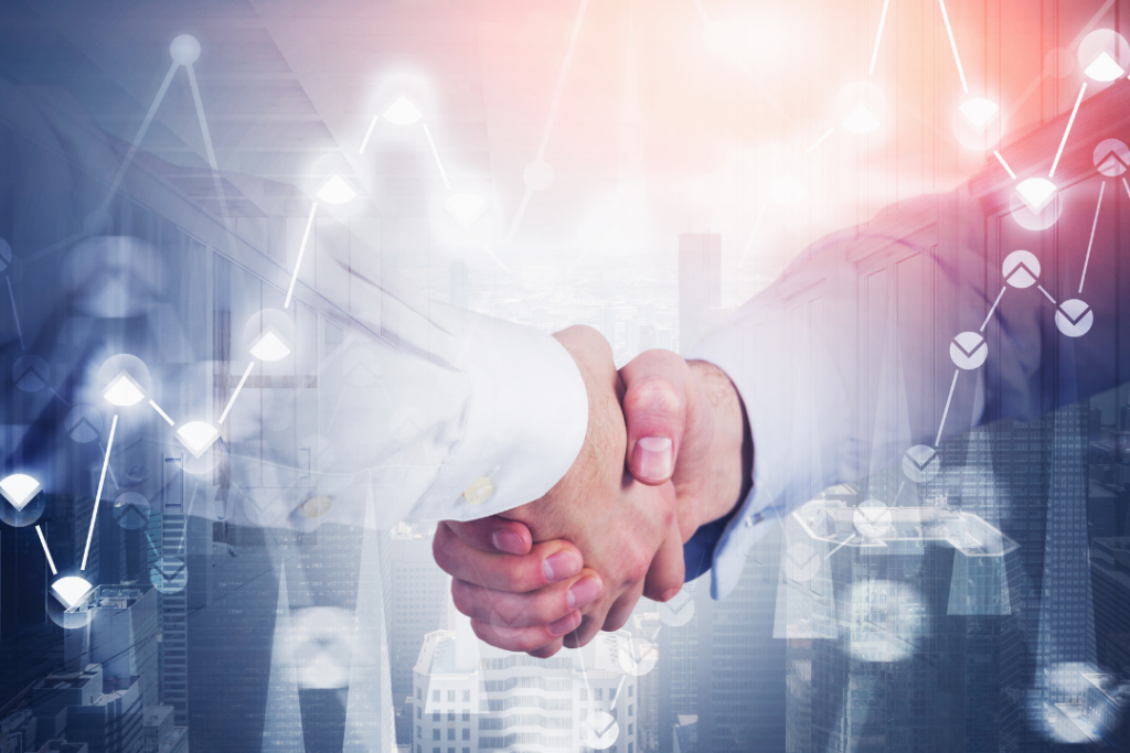 Financial advisors reviewing charts and data during a meeting, with hands pointing and writing on documents that show financial graphs and charts.